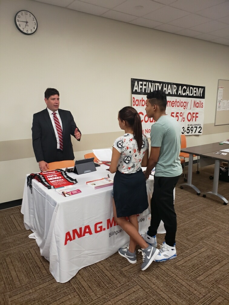 Juniors Sebastian Vargas and Neileen Acosta speak with a rep from Ana G Mendez University about their application process.