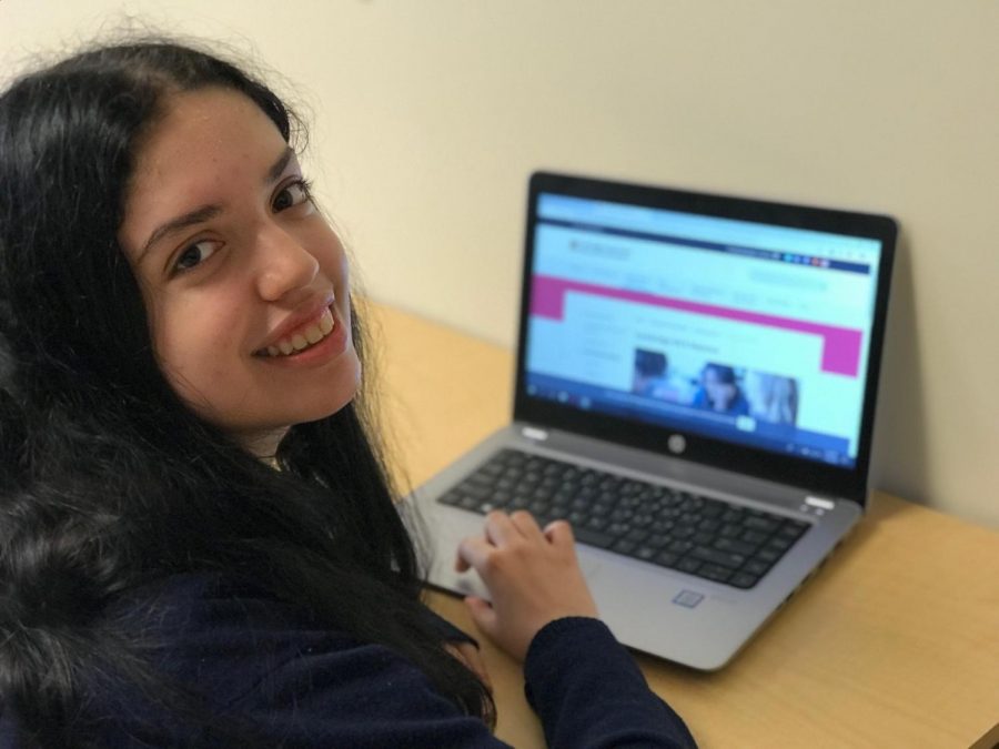 Junior, Faith Nicolas, is seen looking over the information on the AICE website.