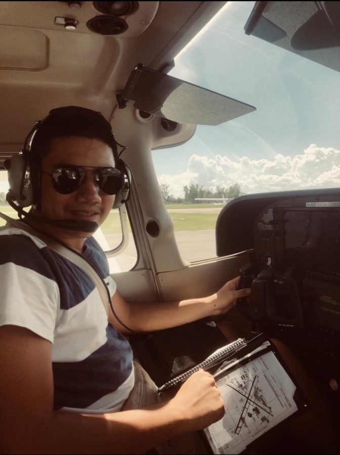 Senior Daniel Rodriguez sits in the pilot seat of an airplane at the Kissimmee Gateway Airport.