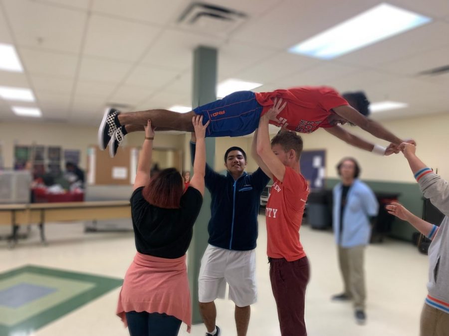 Seniors Dylan Goss, Daniel Rodriguez, and Iancarlo Ayala practice a lift during rehearsals with director Mrs. Julie Gardieff. 