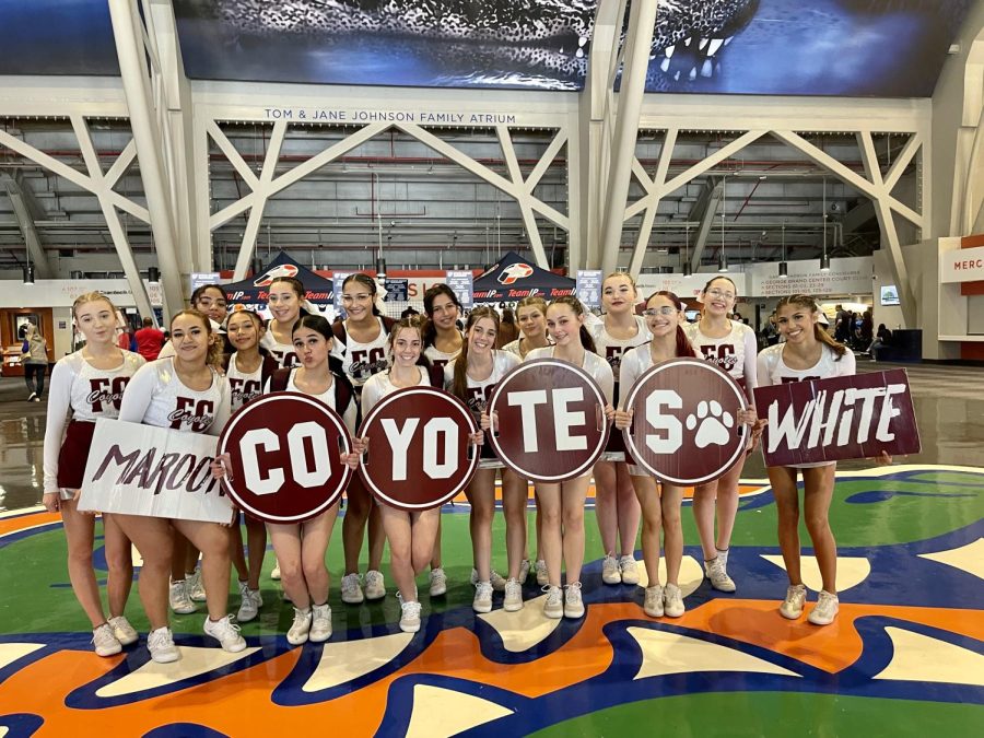 Competitive cheerleading squad stopped for a photo in the Stephen OConnell Center at the University of Florida before competing in the state championship.