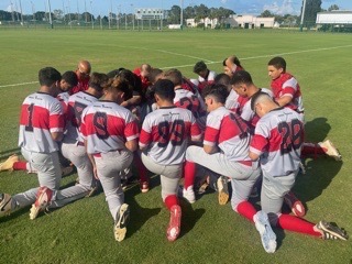 The Coyotes taking a moment to pray before their first home game.