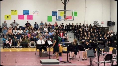 Band and choir performing at their concert in the gym.
