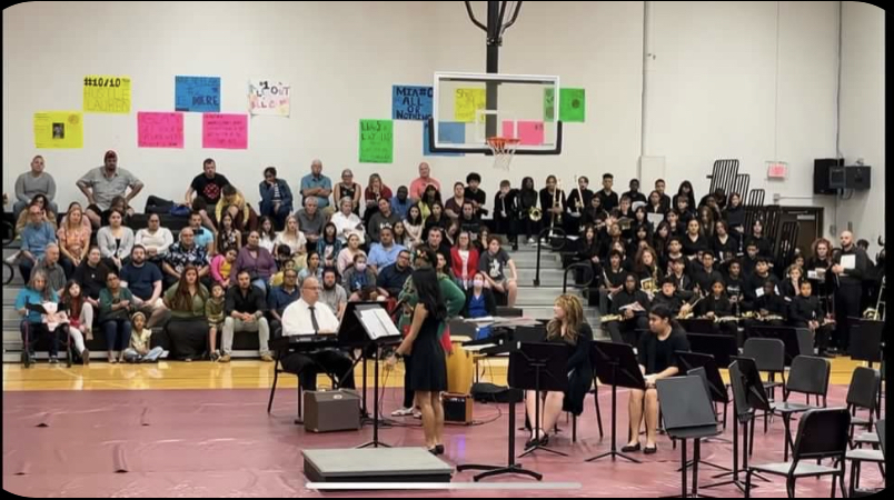 Band and choir performing at their concert in the gym.