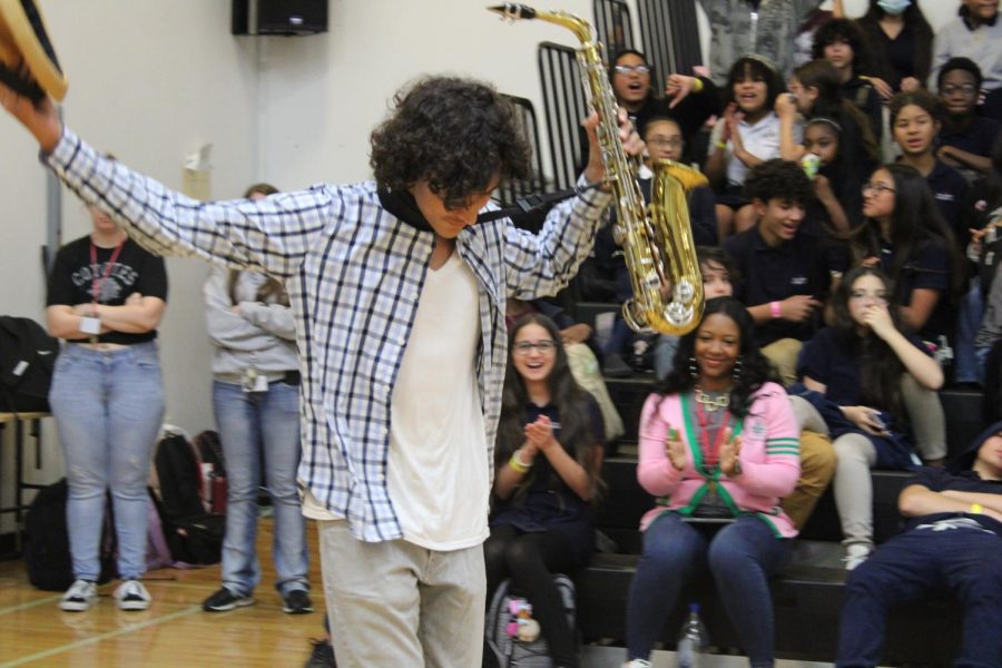 Students cheering for peer Jordin Navedo as he gets ready to play the saxophone.