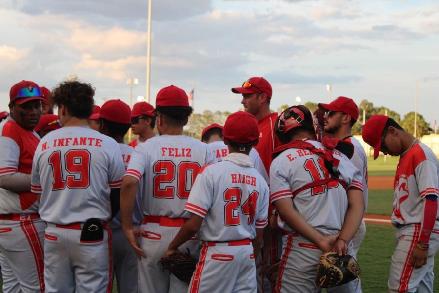 Baseball team discussing tactics before game.