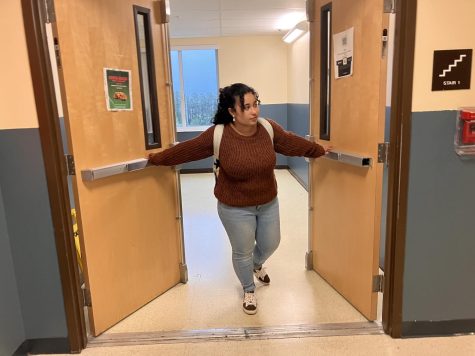 Senior Arianna De Jesus walking through the doors up to the high school hallways.