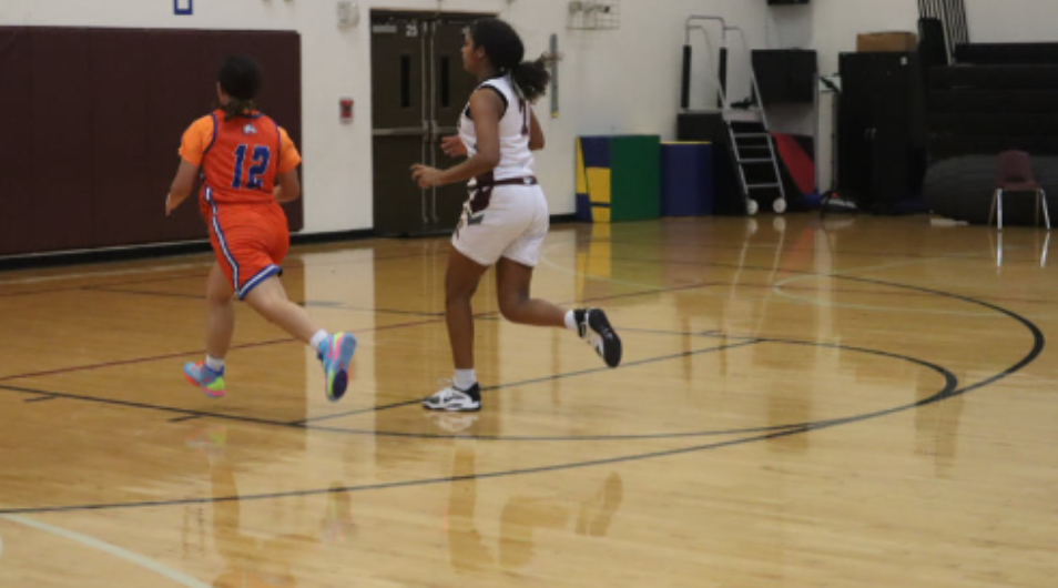 Karina Cruz runs across the court during the basketball game.