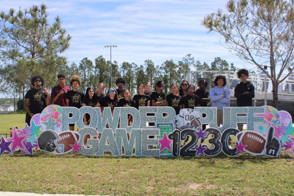 Sophomores pose by the PowderPuff sign.