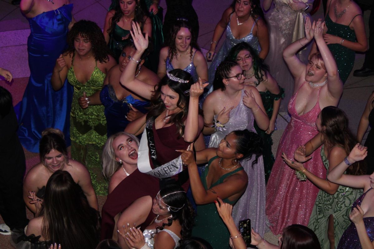 Senior prom queen Chelsea Garcia lifted in the air during a dance at prom.