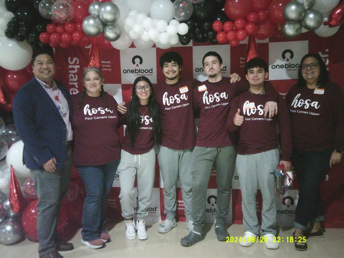 The HOSA club members as well as club advisor Karen Tripp smile for a picture at the blood drive convention. (Mia Villanueva)