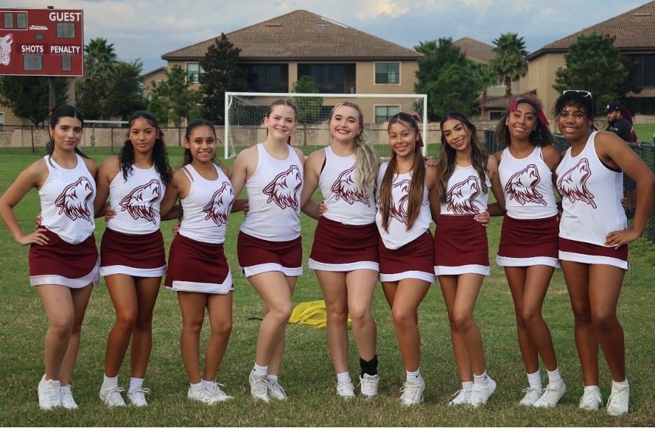 The senior cheerleaders line up for a photo at the first football game of the season. 