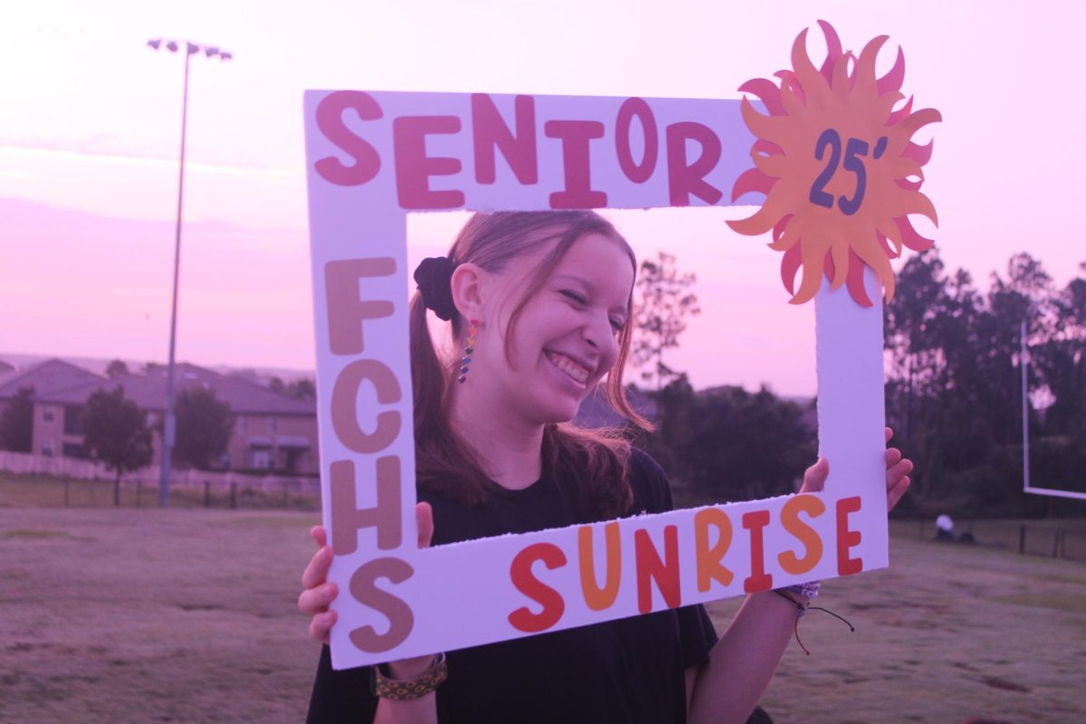 Senior Madeline Seamen smiles for a picture at Senior Sunrise.