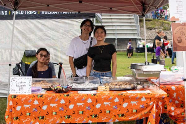 Mia Villanueva accompanied by her friend Gavin Olsowsky and younger sister at the annual Fall Block party. 