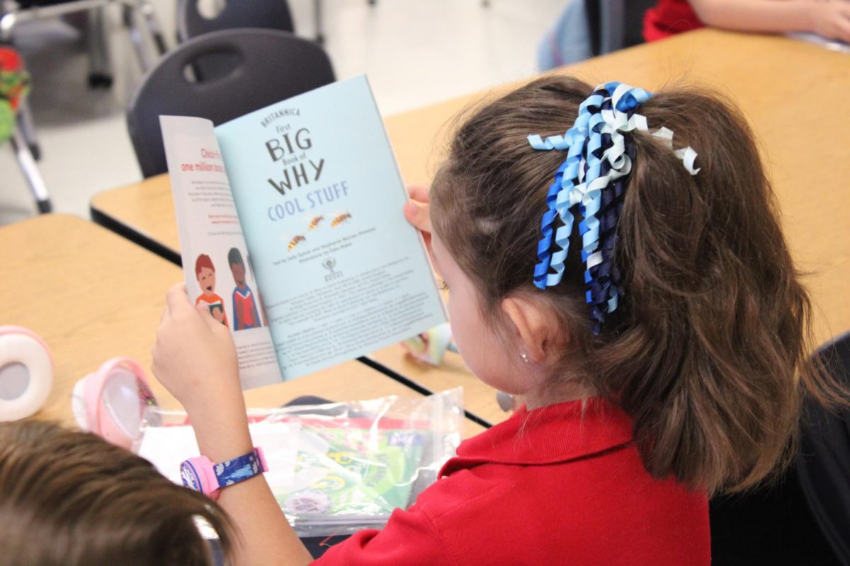 A student reads her new book. 