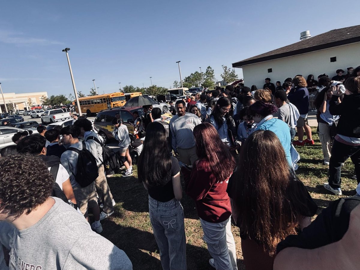 Students standing outside the school on Friday the 20th awaiting news.
