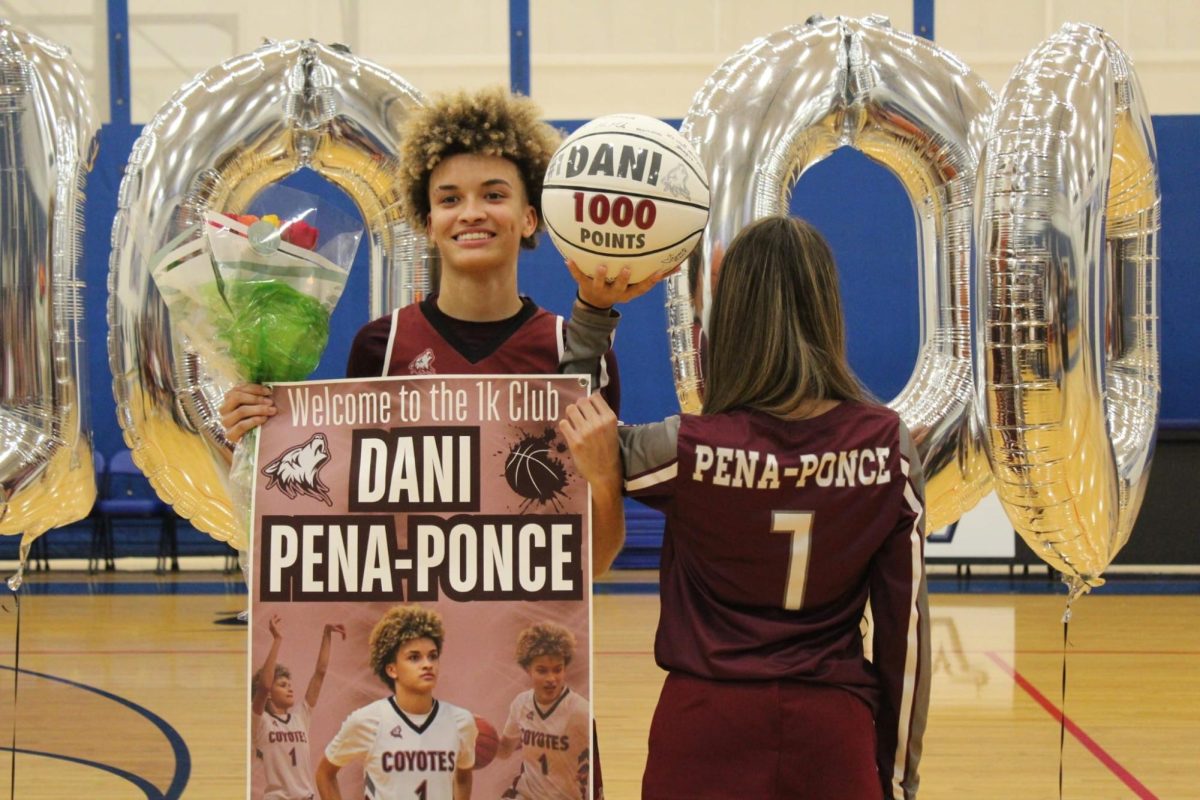 Peña poses with cheerleader as she shows off her name and custom basketball.